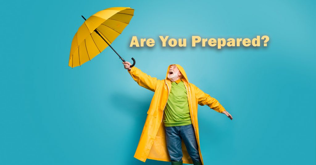 How prepared are you in the event of a natural disaster?  Man in a yellow raincoat with umbrella.